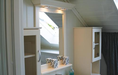 a bathroom with a mirror and a sink at Amazing Home In Farsund With 3 Bedrooms And Wifi in Farsund