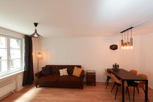 a living room with a couch and a table at KoBi Apartments Falkenplatz in Lucerne