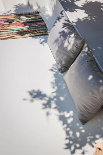 a pair of pillows sitting on top of a table at Bohemian Nest - Cheerful 2-Bedroom Villa with pool in Dhavgáta