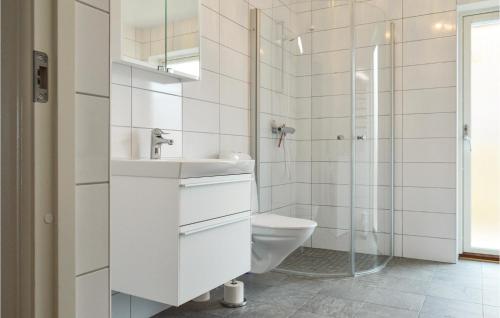 a white bathroom with a toilet and a shower at Cozy Apartment In Rnnng With House Sea View in Rönnäng