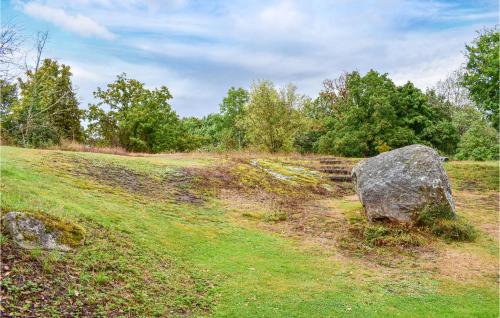 a large rock in a grassy field at Beautiful Home In Asarum in Asarum