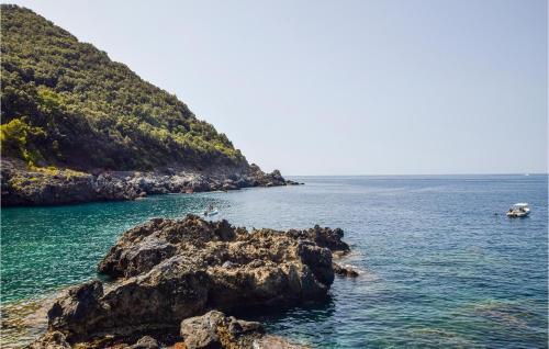 a person standing on a rock in the ocean at Gorgeous Apartment In Ricadi With Wifi in Ricadi