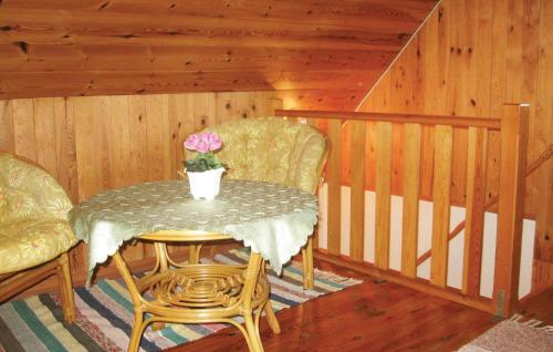 a table with a flower on it in a room at Holiday Home Katthammarsvik 21 in Katthammarsvik