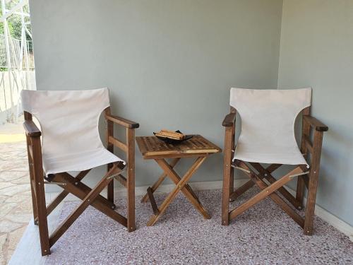 two chairs and a table and a table and a table at Jasmine Villa in Vari
