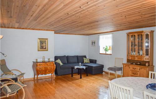 a living room with a couch and a table at Cozy Home In Högsby With Sauna in Aboda
