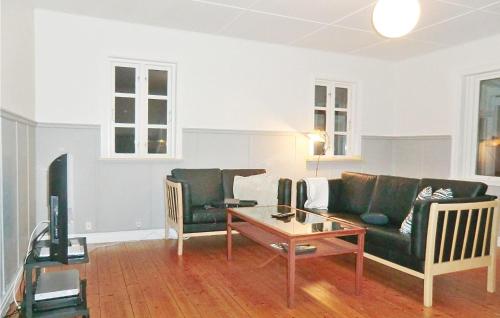 a living room with a couch and a table at Holiday Home Björkvägen Höör in Höör