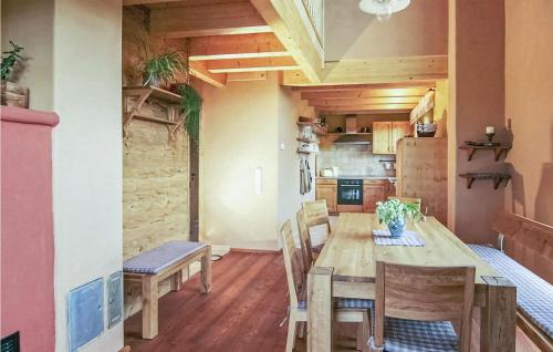 a kitchen and dining room with a wooden table and chairs at Three-Bedroom Holiday Home In Schillingsfurst in Schillingsfürst