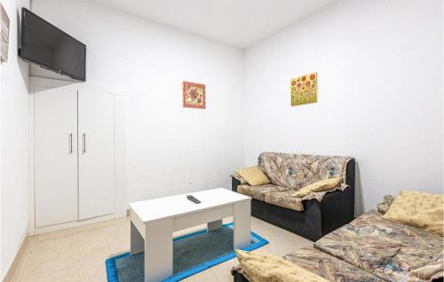 A television and/or entertainment centre at Stunning Home In Fisterra With Kitchen