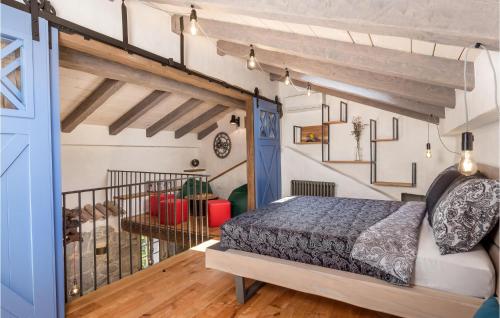 a bedroom with a bed and a staircase at Amazing Home In Mucici With Kitchen in Mučići