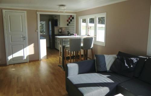 a living room with a couch and a kitchen at Gorgeous Home In Löttorp With Wifi in Löttorp