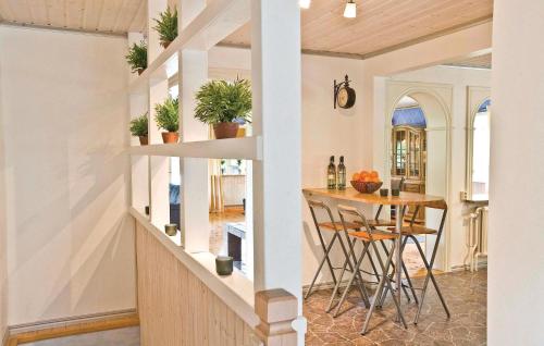 Amazing Home In Trans With Sauna في تراناس: مطبخ وغرفة طعام مع طاولة وكراسي