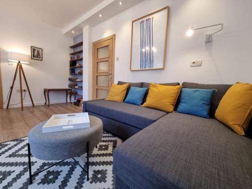 a living room with a couch and a table at Golden Fields Apartment near the Old Town in Kotor
