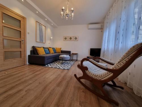 a living room with a couch and a chair at Golden Fields Apartment near the Old Town in Kotor