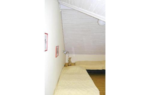 a bedroom with two beds and a window at 4 Bedroom Cozy Home In Ljungsarp in Ljungsarp