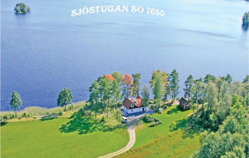 an aerial view of a house on a hill by the water at 4 Bedroom Cozy Home In Ljungsarp in Ljungsarp