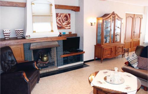 a living room with a fireplace and a tv at Holiday Home Ruiselede 62 With Sauna in Ruiselede