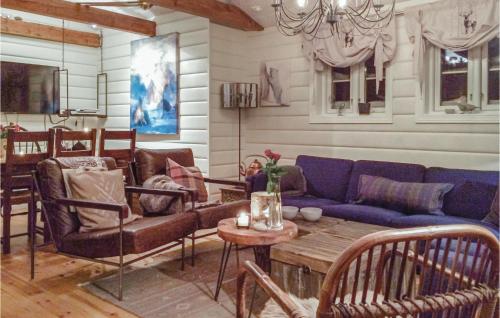 a living room with a blue couch and a table at Pet Friendly Home In Hovden With Sauna in Hovden
