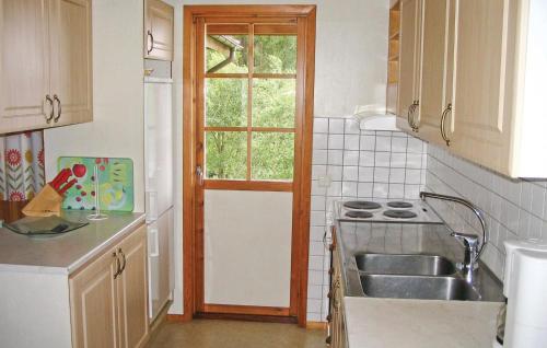 a kitchen with a sink and a window at Nice Home In Gislaved With Sauna in Våthult
