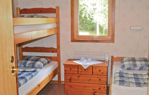 a bedroom with two bunk beds and a window at Nice Home In Gislaved With Sauna in Våthult