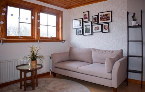 a living room with a couch and a table at Cozy Home In Vittaryd With Wifi in Vittaryd