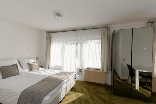 Postel nebo postele na pokoji v ubytování Aparthotel Stoll