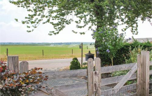 a wooden fence with a view of a field at Room With A View in Sprundel