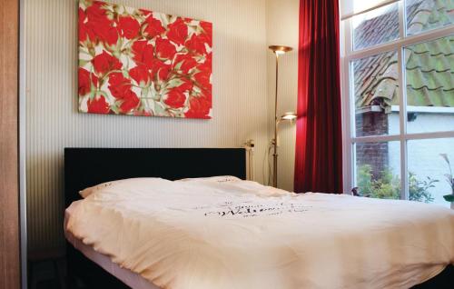 a bedroom with a bed and a window with a painting at Gorgeous Apartment In Molkwerum With House A Panoramic View in Molkwerum