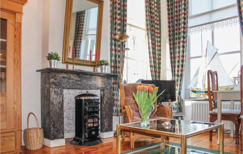 a living room with a fireplace and a table at Cozy Apartment In Molkwerum With Wifi in Molkwerum