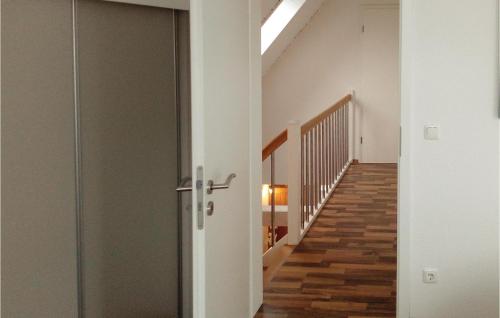 a hallway with a glass door and a staircase at Cozy Apartment In Rechlin With Sauna in Zielow