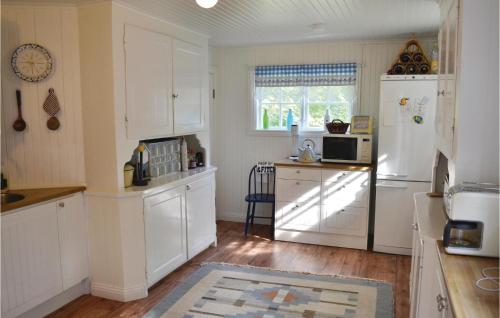 a kitchen with white cabinets and a white refrigerator at Gorgeous Home In Vimmerby With Wifi in Vimmerby
