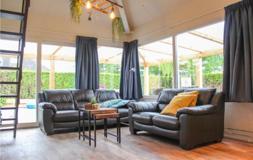 a living room with two leather couches and a table at Oud Kempen Bungalow 173 in Stavenisse
