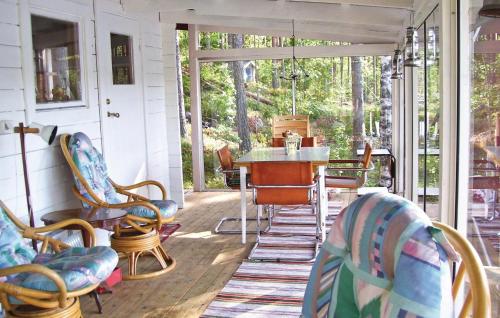 a screened in porch with chairs and a table at 2 Bedroom Nice Home In Falun in Falun