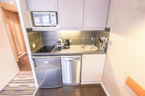 a small kitchen with a sink and a dishwasher at Studio With Balcony In Issy Les Moulineaux in Issy-les-Moulineaux