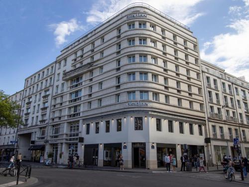 ein großes weißes Gebäude an der Ecke einer Straße in der Unterkunft Citadines Tour Eiffel Paris in Paris