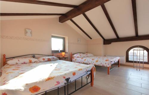 a bedroom with two beds and a window at Lovely Home In Gracisce in Gračišče