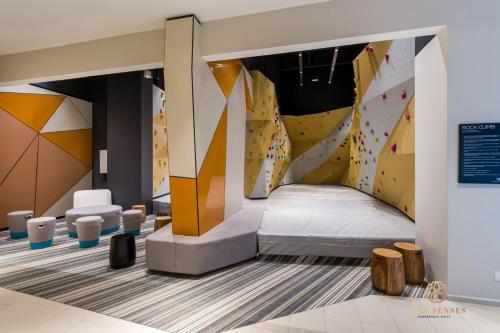 a room with a bed and a climbing wall at ViiA Residences Kuala Lumpur, Five Senses in Kuala Lumpur