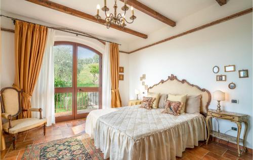 a bedroom with a bed and a large window at Villa I Cedri in Santa Lucia