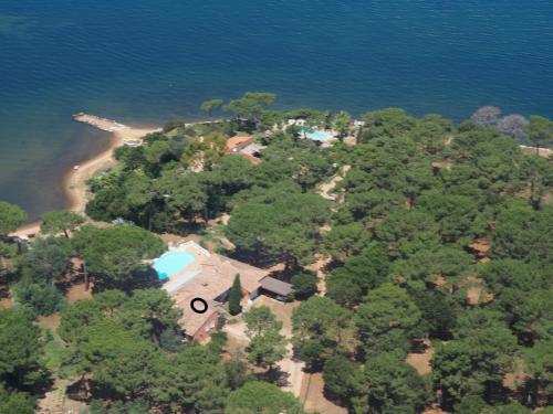 an aerial view of an island in the water at Villa PINEDE in Porto-Vecchio