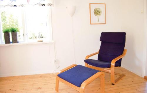 a blue chair sitting in a room next to a window at Stunning Home In Vrigstad With Wifi in Vrigstad