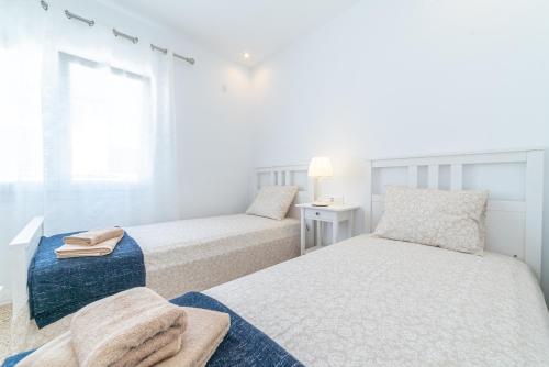 מיטה או מיטות בחדר ב-Apartamento Paraiso de Son Moll