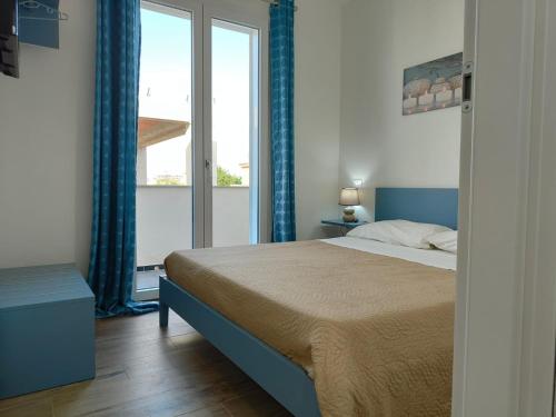 Katil atau katil-katil dalam bilik di L’isola di Cristiano Marzamemi
