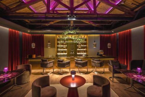 a bar with chairs and a table in a room at HOTEL ANDI Townscape Wuhan in Wuhan
