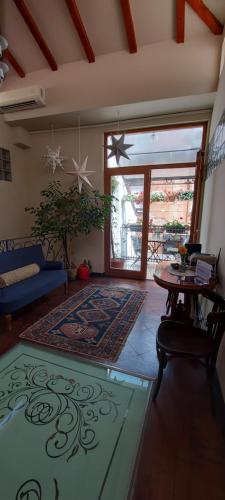 a living room with a table and a rug at Villa Skadarlija in Belgrade