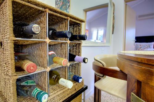 a wine rack with wine bottles on it next to a table at Kanakades Olive Cottage in Kanakádes
