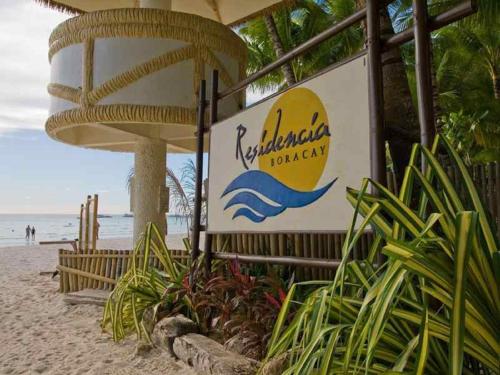 a sign for a hotel on the beach at Residencia Boracay in Boracay