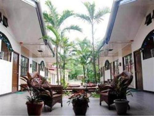 a lobby with chairs and palm trees in a building at Residencia Boracay in Boracay