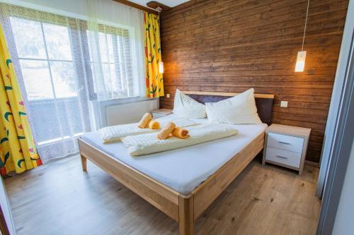 a bedroom with a bed with two teddy bears on it at Huberhof 9 by Alpenidyll Apartments in Schladming