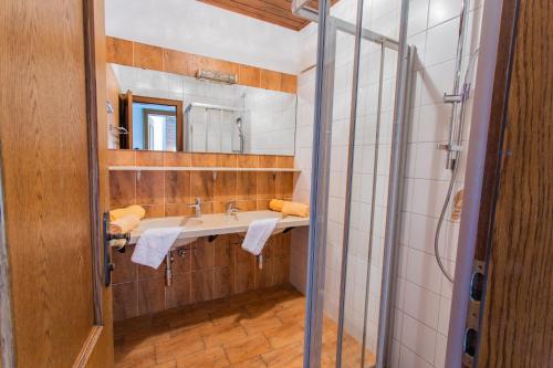 a bathroom with a sink and a mirror at Huberhof 9 by Alpenidyll Apartments in Schladming