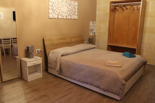 Postel nebo postele na pokoji v ubytování B&B Le Carrube