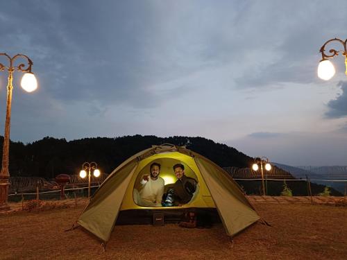 a group of three people in a tent at Skyview by Empyrean in Patnitop